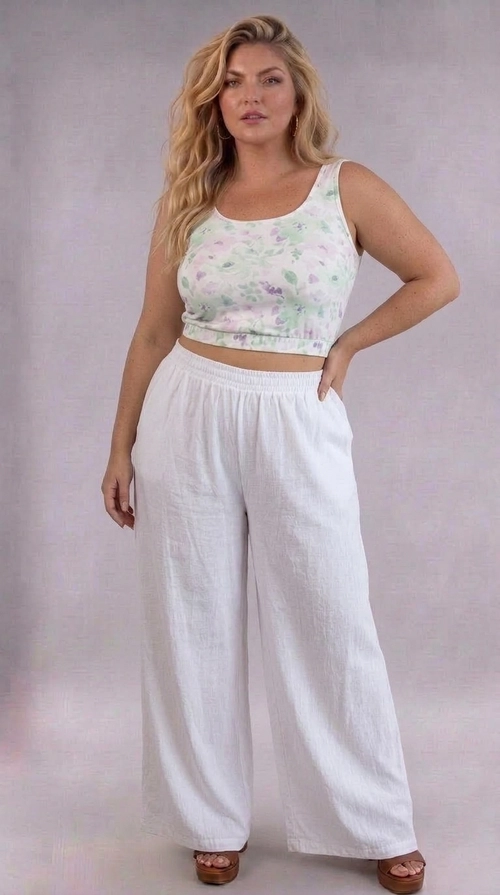 Κροπ τοπ άσπρο καλοκαιρινό plus size - CTSPL123 | Candiashop Boutique, Ανακαλύψτε το απόλυτο καλοκαιρινό κροπ τοπ που θα σας κάνει να λάμψετε! Με λευκό φόντο και ένα ρομαντικό floral μοτίβο σε αποχρώσεις λιλά και μέντας, αυτό το αμάνικο τοπ αποπνέει μια αέρινη, θηλυκή διάθεση που ταιριάζει απόλυτα στις ζεστές καλοκαιρινές μέρες. Η στρογγυλή λαιμόκοψη και η ελαστική λεπτομέρεια στο κάτω μέρος δημιουργούν μια κολακευτική εφαρμογή που αναδεικνύει την καμπύλη σιλουέτα, ενώ ο σχεδιασμός του είναι ειδικά προσαρμοσμένος για plus size γυναίκες. Το μαλακό, ελαφρύ ύφασμα εξασφαλίζει άνεση καθ' όλη τη διάρκεια της ημέρας, ενώ η κοντή γραμμή του το καθιστά ιδανικό για συνδυασμό με φαρδιά λευκά παντελόνια, όπως στη φωτογραφία, αλλά και με ψηλόμεσες φούστες ή σορτς. Ιδανικό για εξόδους στην παραλία, καφέ με φίλες ή καλοκαιρινές βόλτες, αυτό το τοπ είναι η τέλεια επιλογή για κάθε γυναίκα που θέλει να συνδυάσει στυλ και άνεση.