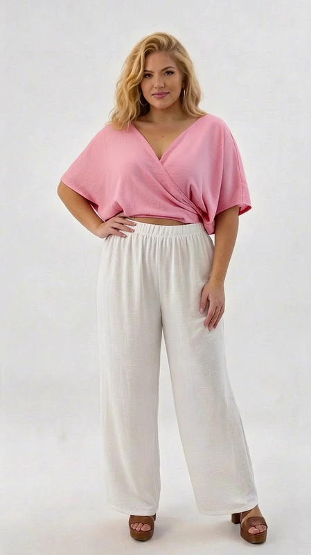 Κροπ τοπ ροζ καλοκαιρινό plus size - CTSPL120 | Candiashop Boutique, Αυτό το εντυπωσιακό σύνολο καλοκαιρινής μόδας για γυναίκες με καμπύλες συνδυάζει κομψότητα και άνεση. Το κροπ τοπ σε υπέροχο τριανταφυλλί χρώμα διαθέτει χαλαρή εφαρμογή με κομψό κρουαζέ σχεδιασμό και φαρδιά μανίκια που κολακεύουν τους ώμους. Η ελαφριά υφή του υφάσματος προσφέρει δροσιά στις ζεστές καλοκαιρινές μέρες, ενώ η κροπ γραμμή αναδεικνύει τη μέση με θηλυκό τρόπο. Συνδυάζεται τέλεια με την άνετη παντελόνα σε λευκό χρώμα που διαθέτει ελαστική μέση για μέγιστη άνεση και φαρδιά γραμμή που χαρίζει αέρινη αίσθηση. Το σύνολο είναι ιδανικό για καλοκαιρινές βόλτες, απογευματινούς καφέδες, αλλά και για βραδινές εξόδους στην παραλία. Μπορεί εύκολα να αναβαθμιστεί με κοσμήματα όπως χρυσά βραχιόλια και εντυπωσιακά σκουλαρίκια για μια πιο επίσημη εμφάνιση. Η αέρινη αίσθηση των υφασμάτων χαρίζει άνετες κινήσεις και κολακευτική εφαρμογή, αναδεικνύοντας τη θηλυκότητα με στιλ και αυτοπεποίθηση.