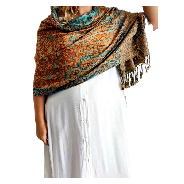 Πολυτελής εσάρπα από 90% κασμίρ και 10% μετάξι, με πλούσια χρώματα και εξαιρετικό σχεδιασμό που αναδεικνύει κάθε εμφάνιση. Η εντυπωσιακή παλέτα χρωμάτων συνδυάζει ζεστές αποχρώσεις πορτοκαλί τερακότα με γαλαζοπράσινες λεπτομέρειες σε ένα μαγευτικό παραδοσιακό μοτίβο paisley. Οι κρόσσια στις άκρες προσθέτουν μια κομψή πινελιά στο συνολικό σχέδιο, ενώ το απαλό ύφασμα αγκαλιάζει τους ώμους με άνεση και ζεστασιά. Ιδανική για βραδινές εξόδους, επίσημες εκδηλώσεις ή καθημερινές περιστάσεις όπου επιθυμείτε να προσθέσετε μια νότα κομψότητας. Συνδυάζεται τέλεια με απλά μονόχρωμα ρούχα, όπως το λευκό φόρεμα της φωτογραφίας, αφήνοντας την εσάρπα να γίνει το επίκεντρο του συνόλου. Μπορεί να φορεθεί ως φουλάρι, ριχτή στους ώμους ή τυλιγμένη γύρω από το λαιμό για προστασία τις κρύες μέρες. Η εξαιρετική ποιότητα του υφάσματος εγγυάται διαχρονική ομορφιά και ανθεκτικότητα.