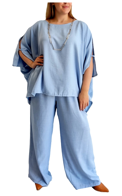 Κομψό σύνολο σε απαλό γαλάζιο χρώμα που συνδυάζει άνεση και στυλ για κάθε περίσταση. Η φαρδιά μπλούζα με τα ανοίγματα στα μανίκια προσφέρει μια αέρινη αίσθηση και χαλαρή εφαρμογή, ιδανική για τις ζεστές καλοκαιρινές ημέρες. Συνδυάζεται με φαρδύ παντελόνι στην ίδια γαλάζια απόχρωση, δημιουργώντας ένα αρμονικό σύνολο που κολακεύει κάθε σωματότυπο. Το λινό ύφασμα χαρίζει μια πολυτελή αίσθηση, ενώ παράλληλα επιτρέπει στο δέρμα να αναπνέει. Οι χαλαρές γραμμές του συνόλου το καθιστούν ιδανική επιλογή για καθημερινές εμφανίσεις, αλλά και για πιο κομψές περιστάσεις όταν συνδυάζεται με τα κατάλληλα αξεσουάρ, όπως η εντυπωσιακή αλυσιδωτή ασημένια κολιέ που φαίνεται στη φωτογραφία. Φορέστε το με επίπεδα σανδάλια για μια καθημερινή εμφάνιση ή με κομψά μποτάκια για ένα πιο εκλεπτυσμένο στυλ. Ιδανικό για βόλτες στην πόλη, καλοκαιρινές αποδράσεις ή χαλαρά επαγγελματικά περιβάλλοντα.