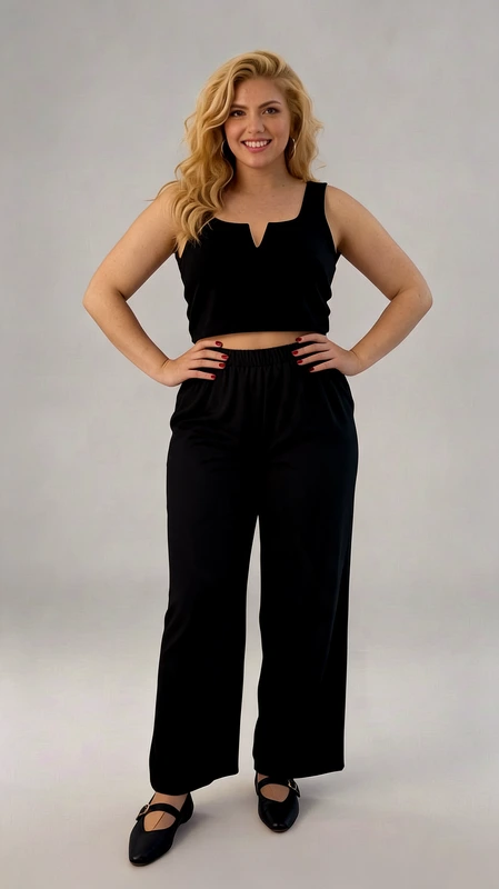 Παντελόνα γυναικεία plus size ανοιξιάτικη μαύρη - PANT170 | Candiashop Boutique, Αυτό το κομψό σετ δύο τεμαχίων σε βαθύ μπλε σκούρο (μαύρο-μπλε) αποτελεί την ιδανική επιλογή για την καλοκαιρινή σας γκαρνταρόμπα. Το άνω μέρος είναι ένα μοντέρνο crop top με φαρδιές τιράντες και ιδιαίτερο V-σχήμα στο ντεκολτέ που κολακεύει κάθε σιλουέτα. Συνδυάζεται με μια φαρδιά, άνετη παντελόνα με ελαστική μέση που προσφέρει εξαιρετική άνεση κατά τη διάρκεια της ημέρας. Το υλικό είναι απαλό και ρέον, δημιουργώντας μια αέρινη αίσθηση που είναι ιδανική για ζεστές καλοκαιρινές μέρες ή βραδινές εξόδους. Η παντελόνα διαθέτει φαρδιά γραμμή που χαρίζει κομψότητα και στυλ, ενώ παράλληλα δημιουργεί μια εντυπωσιακή σιλουέτα. Φορέστε αυτό το σύνολο με ψηλοτάκουνα παπούτσια για βραδινές εξόδους ή με σανδάλια για πιο καθημερινές περιστάσεις. Συνδυάστε το με κοσμήματα σε χρυσές αποχρώσεις και μια μικρή τσάντα για να ολοκληρώσετε το look σας. Διατίθεται σε διάφορα μεγέθη για να ταιριάζει σε κάθε σωματότυπο.