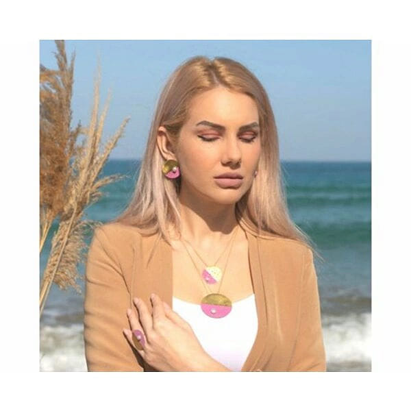 Σκουλαρίκια κρίκοι με μαργαριτάρια και χρώμα - 12152, Ανακαλύψτε τη μαγεία των χρωμάτων με αυτά τα εντυπωσιακά σκουλαρίκια κρίκοι που συνδυάζουν το ζεστό χρυσό με το παιχνιδιάρικο ροζ, σχεδιασμένα από την Ελληνίδα Σχεδιάστρια Κοσμημάτων Αικατερίνη Χαλκιαδάκη. Κάθε κομμάτι διακοσμείται με λεπτές τρύπες που δημιουργούν ένα μοντέρνο geometric pattern, ενώ οι φυσικές πέρλες προσθέτουν μια νότα κομψότητας.
Αυτά τα χειροποίητα σκουλαρίκια από ορείχαλκο αποτελούν την ιδανική επιλογή για γυναίκες που αγαπούν τα statement κοσμήματα με contemporary αισθητική. Ο συνδυασμός των ζωντανών χρωμάτων τα καθιστά τέλεια για καλοκαιρινά look, ενώ η κλασική φόρμα των κρίκων εξασφαλίζει διαχρονική απήχηση.
Το ασύμμετρο design με τους διχρωμικούς κρίκους δημιουργεί visual interest και προσθέτει μια πινελιά playful elegance στην εμφάνισή σας. Ιδανικά για καθημερινό styling αλλά και για ειδικές εξόδους που θέλετε να ξεχωρίσετε. Αποφύγετε την επαφή με νερό και αρώματα για να διατηρήσετε τη λάμψη τους.