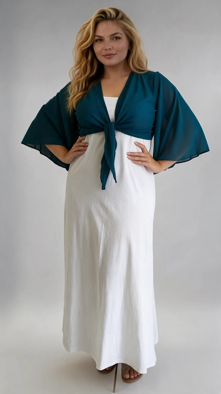 Μπολερό πετρόλ καλοκαιρινό plus size - BOL113 | Candiashop Boutique, Ανακαλύψτε το απόλυτο καλοκαιρινό αξεσουάρ με αυτό το εντυπωσιακό μπολερό plus size σε βαθύ πετρόλ χρώμα. Κατασκευασμένο από ελαφρύ, διαφανές ύφασμα σιφόν, προσφέρει μια αέρινη και θηλυκή αίσθηση που ταιριάζει απόλυτα στις ζεστές καλοκαιρινές μέρες. Το ιδιαίτερο χαρακτηριστικό του είναι τα φαρδιά μανίκια τύπου kimono που δίνουν μια δραματική και κομψή πινελιά, ενώ το μπροστινό δέσιμο με κόμπο επιτρέπει να ρυθμίσετε την εφαρμογή σύμφωνα με τις προτιμήσεις σας. Το σχέδιο αυτό κολακεύει ιδιαίτερα τις plus size σιλουέτες, καθώς τονίζει τη μέση και δημιουργεί μια ισορροπημένη γραμμή. Μπορεί να φορεθεί πάνω από φορέματα, όπως το λευκό maxi φόρεμα της φωτογραφίας, αλλά και με ψηλόμεσα παντελόνια ή φούστες για ένα casual chic αποτέλεσμα. Ιδανικό για βραδινές εξόδους, καλοκαιρινά πάρτι, γάμους και διακοπές, αυτό το μπολερό θα γίνει αναπόσπαστο κομμάτι της καλοκαιρινής σας γκαρνταρόμπας.
