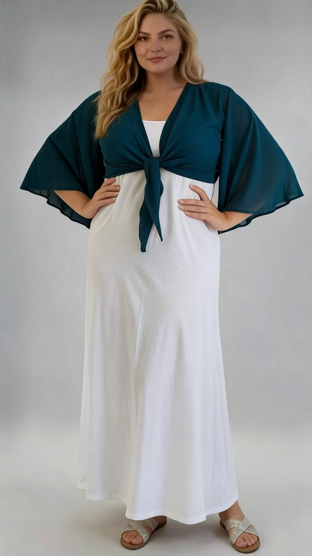 Μπολερό πετρόλ καλοκαιρινό plus size - BOL113 | Candiashop Boutique, Ανακαλύψτε το απόλυτο καλοκαιρινό αξεσουάρ με αυτό το εντυπωσιακό μπολερό plus size σε βαθύ πετρόλ χρώμα. Κατασκευασμένο από ελαφρύ, διαφανές ύφασμα σιφόν, προσφέρει μια αέρινη και θηλυκή αίσθηση που ταιριάζει απόλυτα στις ζεστές καλοκαιρινές μέρες. Το ιδιαίτερο χαρακτηριστικό του είναι τα φαρδιά μανίκια τύπου kimono που δίνουν μια δραματική και κομψή πινελιά, ενώ το μπροστινό δέσιμο με κόμπο επιτρέπει να ρυθμίσετε την εφαρμογή σύμφωνα με τις προτιμήσεις σας. Το σχέδιο αυτό κολακεύει ιδιαίτερα τις plus size σιλουέτες, καθώς τονίζει τη μέση και δημιουργεί μια ισορροπημένη γραμμή. Μπορεί να φορεθεί πάνω από φορέματα, όπως το λευκό maxi φόρεμα της φωτογραφίας, αλλά και με ψηλόμεσα παντελόνια ή φούστες για ένα casual chic αποτέλεσμα. Ιδανικό για βραδινές εξόδους, καλοκαιρινά πάρτι, γάμους και διακοπές, αυτό το μπολερό θα γίνει αναπόσπαστο κομμάτι της καλοκαιρινής σας γκαρνταρόμπας.