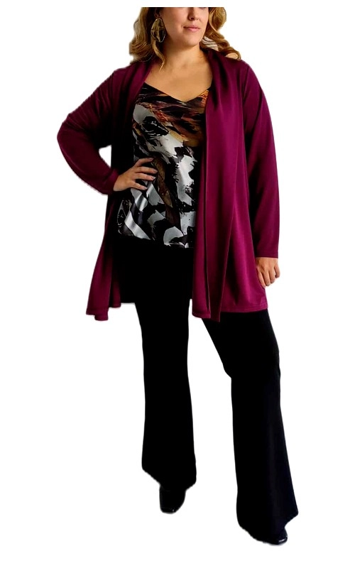 Αυτή η κομψή ζακέτα μπορντό σε plus size είναι το απόλυτο κομμάτι για να αναβαθμίσετε την γκαρνταρόμπα σας. Με το πλούσιο βαθύ μπορντό χρώμα της, προσθέτει μια νότα πολυτέλειας σε κάθε εμφάνιση. Η ζακέτα έχει μακριά μανίκια και ανοιχτή γραμμή μπροστά που δημιουργεί μια κολακευτική σιλουέτα, ενώ το απαλό ύφασμά της προσφέρει άνεση όλη την ημέρα. Συνδυάζεται τέλεια με μπλούζες με μοτίβα όπως αυτή της φωτογραφίας και μαύρα παντελόνια για ένα κομψό καθημερινό ή επαγγελματικό look. Η ρέουσα γραμμή της χαρίζει κίνηση και θηλυκότητα, ενώ το μήκος της καλύπτει στρατηγικά τους γοφούς. Το μαλακό της ύφασμα την καθιστά ιδανική για μεταβατικές εποχές, ενώ μπορεί να φορεθεί από το πρωί στο γραφείο μέχρι το βράδυ για ένα δείπνο. Η ευέλικτη αυτή ζακέτα αποτελεί βασικό κομμάτι για κάθε ντουλάπα, καθώς μπορεί να συνδυαστεί με αμέτρητους τρόπους και να προσθέσει κομψότητα σε οποιοδήποτε σύνολο. Η άνετη εφαρμογή της κολακεύει κάθε σωματότυπο, χαρίζοντας αυτοπεποίθηση και στυλ.
