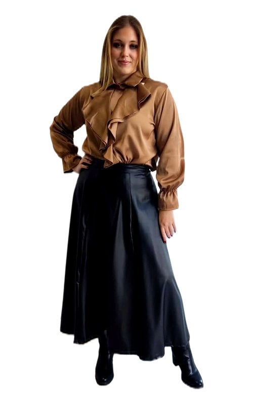 Μια εντυπωσιακή γυναικεία πουκαμίσα σε πλούσια καμηλό απόχρωση που αναδεικνύει την κομψότητα και τη θηλυκότητα. Κατασκευασμένη από σατέν ύφασμα με λαμπερή υφή, προσφέρει μια πολυτελή αίσθηση που κάνει τη διαφορά σε κάθε εμφάνιση. Το κύριο χαρακτηριστικό της είναι η εντυπωσιακή βολάν διακόσμηση στο μπροστινό μέρος, που ξεκινά από τον λαιμό και κατεβαίνει διαγώνια, δημιουργώντας ένα ρομαντικό και δραματικό αποτέλεσμα. Ο γιακάς με φιόγκο προσθέτει μια vintage πινελιά, ενώ τα μακριά μανίκια με ελαστική μανσέτα εξασφαλίζουν άνεση και κομψή εφαρμογή. Ιδανική για plus size σιλουέτες, η γραμμή της αγκαλιάζει το σώμα με χάρη. Μπορεί να φορεθεί με μαύρη δερμάτινη φούστα για ένα sophisticated βραδινό look, με κλασικό παντελόνι για επαγγελματικές περιστάσεις ή ακόμα και με τζιν για μια πιο casual εμφάνιση. Μια διαχρονική επιλογή που συνδυάζει στυλ, άνεση και θηλυκότητα.