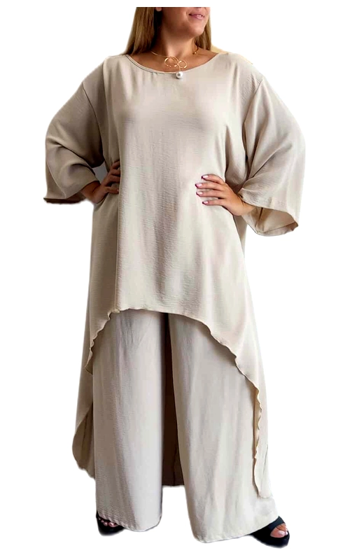 Κομψό σετ σε απαλό εκρού χρώμα που συνδυάζει άνεση και στυλ για κάθε περίσταση. Η φαρδιά μπλούζα με τον ασύμμετρο σχεδιασμό διαθέτει μακριά φαρδιά μανίκια που προσφέρουν αέρινη αίσθηση, ενώ το μήκος της είναι μεγαλύτερο στο πίσω μέρος δημιουργώντας μια κολακευτική σιλουέτα. Το φαρδύ παντελόνι με την ελαστική μέση συμπληρώνει τέλεια το σύνολο, χαρίζοντας άνεση και κίνηση. Το υλικό είναι ελαφρύ και αέρινο, ιδανικό για τις ζεστές καλοκαιρινές μέρες αλλά και για τις δροσερές βραδιές. Μπορεί να φορεθεί τόσο σε καθημερινές εξόδους όσο και σε πιο επίσημες περιστάσεις, συνδυασμένο με ένα κομψό κόσμημα όπως το διακριτικό κολιέ που φαίνεται στη φωτογραφία. Το σετ προσφέρει μια διαχρονική κομψότητα που ταιριάζει σε κάθε σωματότυπο, ενώ η χαλαρή γραμμή του το καθιστά ιδανική επιλογή για άνετο καλοκαιρινό ντύσιμο με στυλ.