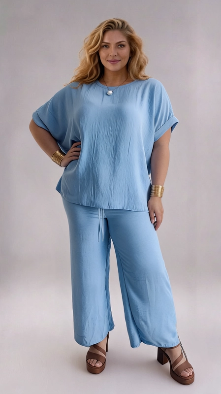 Σετ παντελόνι και μπλούζα γαλάζιο - SET137 | Candiashop Boutique, Ανακαλύψτε την απόλυτη άνεση και το αναλλοίωτο στυλ με αυτό το εντυπωσιακό σετ δύο τεμαχίων σε γαλάζιο χρώμα ουρανού. Η υφή του υφάσματος, με την ελαφρά ζαρωματιά του, προσδίδει έναν αέρινο και καλοκαιρινό χαρακτήρα, ενώ παράλληλα εξασφαλίζει εξαιρετική άνεση καθ' όλη τη διάρκεια της ημέρας. Η φαρδιά μπλούζα με τον στρογγυλό λαιμό και τα κοντά μανίκια με διπλωμένο τελείωμα δίνει μια χαλαρή, boho αίσθηση, ενώ το παντελόνι palazzo με το ελαστικό κορδόνι στη μέση εξασφαλίζει τέλεια εφαρμογή και ελευθερία κινήσεων. Η φαρδιά γραμμή του παντελονιού κολακεύει κάθε σωματότυπο, δημιουργώντας μια κομψή και επιμηκυμένη σιλουέτα. Ιδανικό για καλοκαιρινές βόλτες, casual συναντήσεις ή ακόμα και για χαλαρές ημέρες στη δουλειά. Μπορεί να συνδυαστεί με χρυσά αξεσουάρ και πέδιλα για ένα ολοκληρωμένο, θηλυκό look που θα σας κάνει να ξεχωρίζετε. Ένα must-have κομμάτι της γκαρνταρόμπας σας για κάθε περίσταση!