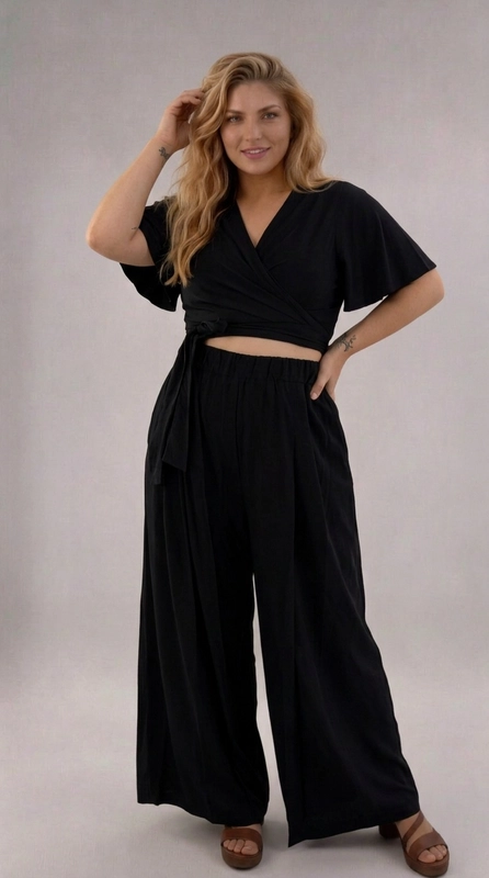 Σετ παντελόνι και μπλούζα μαύρο - SET147 | Candiashop Boutique, Ανακαλύψτε το απόλυτο σετ δύο τεμαχίων σε βαθύ μαύρο χρώμα, που συνδυάζει κομψότητα και άνεση σε ένα μοναδικό σύνολο. Η κροπ μπλούζα με το κρουαζέ σχέδιο και τα φαρδιά μανίκια butterfly δημιουργεί μια θηλυκή και ρομαντική σιλουέτα, ενώ το δέσιμο στη μέση επιτρέπει την προσαρμογή της εφαρμογής στο σώμα σας. Το παντελόνι με την ελαστική μέση και την palazzo γραμμή χαρίζει απεριόριστη άνεση, ενώ οι πλαϊνές τσέπες προσθέτουν πρακτικότητα στο σύνολο. Το λείο, ρέον ύφασμα κινείται χαριτωμένα με κάθε βήμα, δημιουργώντας μια εντυπωσιακή εμφάνιση. Το αμιγώς μαύρο χρώμα το καθιστά ευέλικτο και διαχρονικό, κατάλληλο για καλοκαιρινές βόλτες, ρομαντικά ραντεβού, αλλά και για πιο επίσημες περιστάσεις. Μπορεί να φορεθεί με ψηλοτάκουνα πέδιλα για βραδινή έξοδο ή με flat σανδάλια για έναν πιο casual, καθημερινό look. Ένα σετ που αξίζει να έχετε στη γκαρνταρόμπα σας!