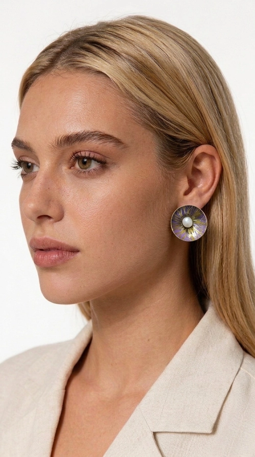 Σκουλαρίκια καρφωτά με πέρλες σε μοβ - SKOUL-4761 | Candiashop Boutique, Τα χειροποίητα καρφωτά σκουλαρίκια με πέρλες σε μοβ αποτελούν μια κομψή επιλογή για κάθε γυναίκα που αναζητά κοσμήματα με χαρακτήρα και αίσθηση. Σχεδιασμένα από την Ελληνίδα Σχεδιάστρια Κοσμημάτων Αικατερίνη Χαλκιαδάκη, αυτά τα μοναδικά σκουλαρίκια συνδυάζουν την εκλεπτυσμένη αισθητική με την ανθεκτικότητα του ορείχαλκου και τη ζεστασιά του χειροποίητου σμάλτου, δημιουργώντας ένα αποτέλεσμα που ξεχωρίζει.
Κάθε ζευγάρι διαθέτει κυκλική φόρμα σε λιλά-μοβ απόχρωση με χρυσές χάλκινες λεπτομέρειες, ενώ στο κέντρο δεσπόζει μια φυσική πέρλα που προσδίδει γοητεία και θηλυκότητα. Η ματ υφή του σμάλτου σε συνδυασμό με την απαλή λάμψη της πέρλας δημιουργεί μια αντίθεση που κάνει το κόσμημα να ξεχωρίζει τόσο σε καθημερινό look όσο και σε επίσημες εμφανίσεις, γάμους και βαφτίσια.
Ιδανικά για δώρο ή προσωπική χρήση, ταιριάζουν με minimal ντύσιμο, casual στυλ αλλά και με επίσημες εμφανίσεις. Η ελαφριά κατασκευή τους εξασφαλίζει άνεση σε καθημερινή χρήση.
