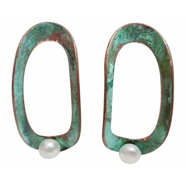 Ανακαλύψτε τη μοναδική ομορφιά αυτών των καρφωτών σκουλαρικιών με μαργαριτάρια που συνδυάζουν τη φινέτσα με τη μοντέρνα αισθητική. Σχεδιασμένα από την Ελληνίδα Σχεδιάστρια Κοσμημάτων Αικατερίνη Χαλκιαδάκη, τα εντυπωσιακά σκουλαρίκια αυτά παρουσιάζουν έναν πρωτότυπο οβάλ σχεδιασμό με χαλκό και πράσινη πατίνα που δημιουργεί μια vintage αισθητική.\u000AΚάθε σκουλαρίκι διαθέτει μια λεπτή πέρλα στο κάτω μέρος που προσθέτει κομψότητα και θηλυκότητα στο γεωμετρικό σχήμα. Η πράσινη πατίνα του χαλκού δημιουργεί μια μοναδική υφή και χρωματική διαβάθμιση που κάνει κάθε κόσμημα μοναδικό. Τα χειροποίητα σκουλαρίκια αυτά είναι ιδανικά για γυναίκες που αγαπούν τα statement κοσμήματα με καλλιτεχνικό χαρακτήρα.