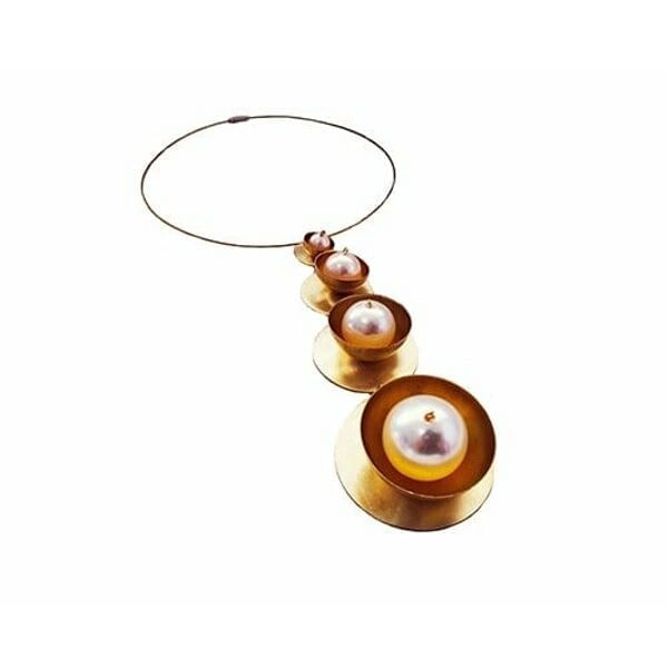 Μεγάλο γυναικείο κολιέ μακρύ με πέρλες - 2986, Ανακαλύψτε τη μαγεία του μεγάλου γυναικείου κολιέ μακρύ με πέρλες, ένα εντυπωσιακό χειροποίητο κόσμημα που συνδυάζει την κλασική κομψότητα με τη μοντέρνα αισθητική. Σχεδιασμένο από την Ελληνίδα Σχεδιάστρια Κοσμημάτων Αικατερίνη Χαλκιαδάκη, αυτό το statement κολιέ μεταμορφώνει κάθε εμφάνιση σε μια υπόθεση στυλ.
Το μοναδικό σχέδιο παρουσιάζει πέντε κυκλικούς δίσκους από ορείχαλκο σε χρυσή απόχρωση, που μειώνονται προοδευτικά σε μέγεθος και φιλοξενούν λευκές πέρλες διαφορετικών διαστάσεων. Η γεωμετρική διάταξη δημιουργεί ένα εντυπωσιακό οπτικό αποτέλεσμα που προσελκύει το βλέμμα, ενώ το λεπτό metal wire καλώδιο εξασφαλίζει άνετη εφαρμογή.
Αυτό το μακρύ κολιέ με μαργαριτάρια είναι ιδανικό για βραδινές εμφανίσεις, ειδικές περιστάσεις ή για να προσθέσετε μια δόση κομψότητας στην καθημερινή σας εμφάνιση. Συνδυάζεται τέλεια με μονόχρωμα outfits και προσφέρει endless layering δυνατότητες.